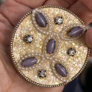 Vintage compact, purple cabochon, pearl and diamond aurora borealis background